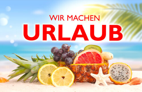 Obst am Strand mit Schrift "Wir machen Urlaub"